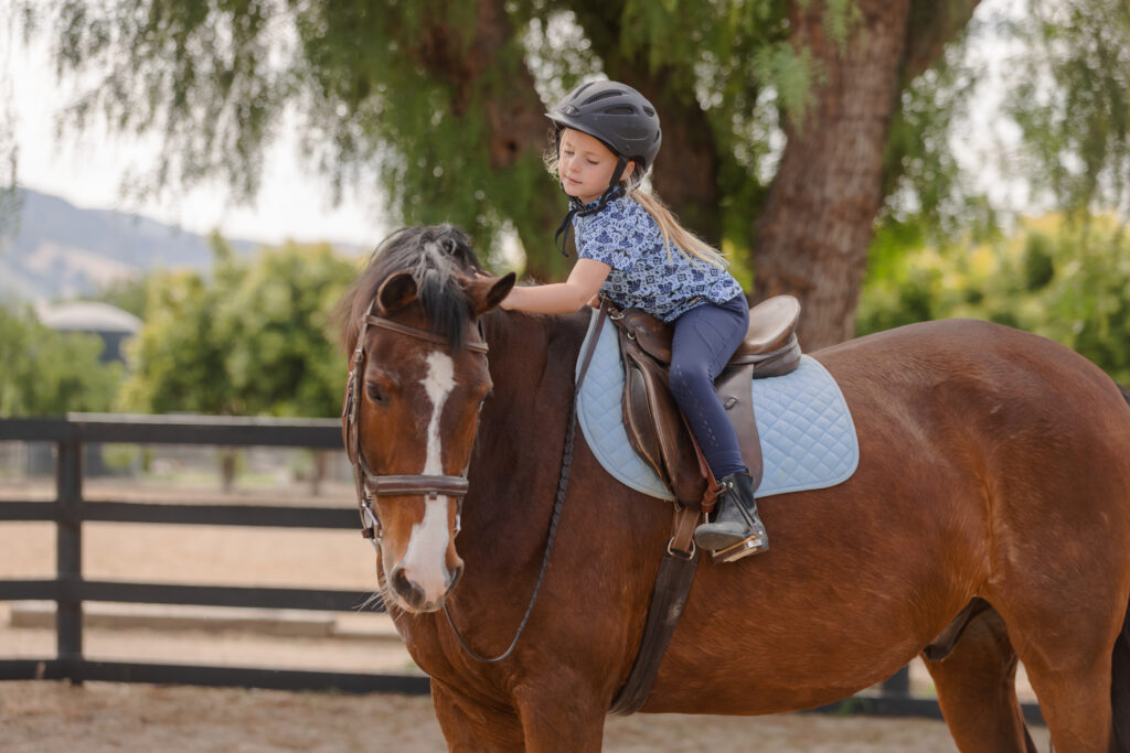 KERRI program is a rehabilitation and rehoming program for OTTBs, the picture shows a young girl on horse.